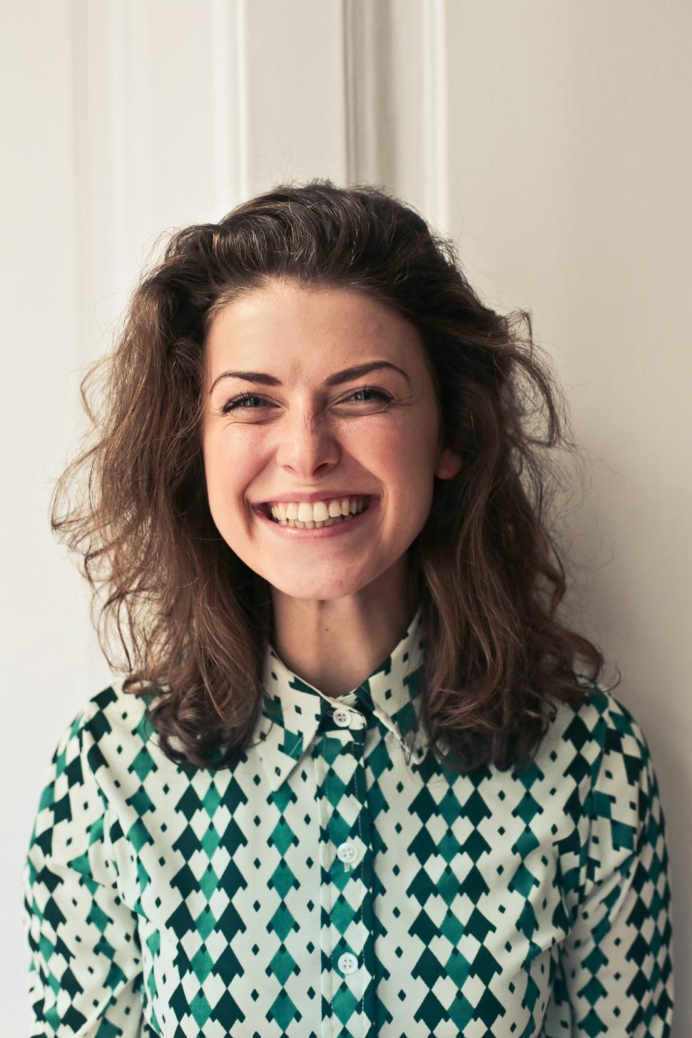 young-woman-in-printed-collared-shirt-seen-smiling-as-looking-at